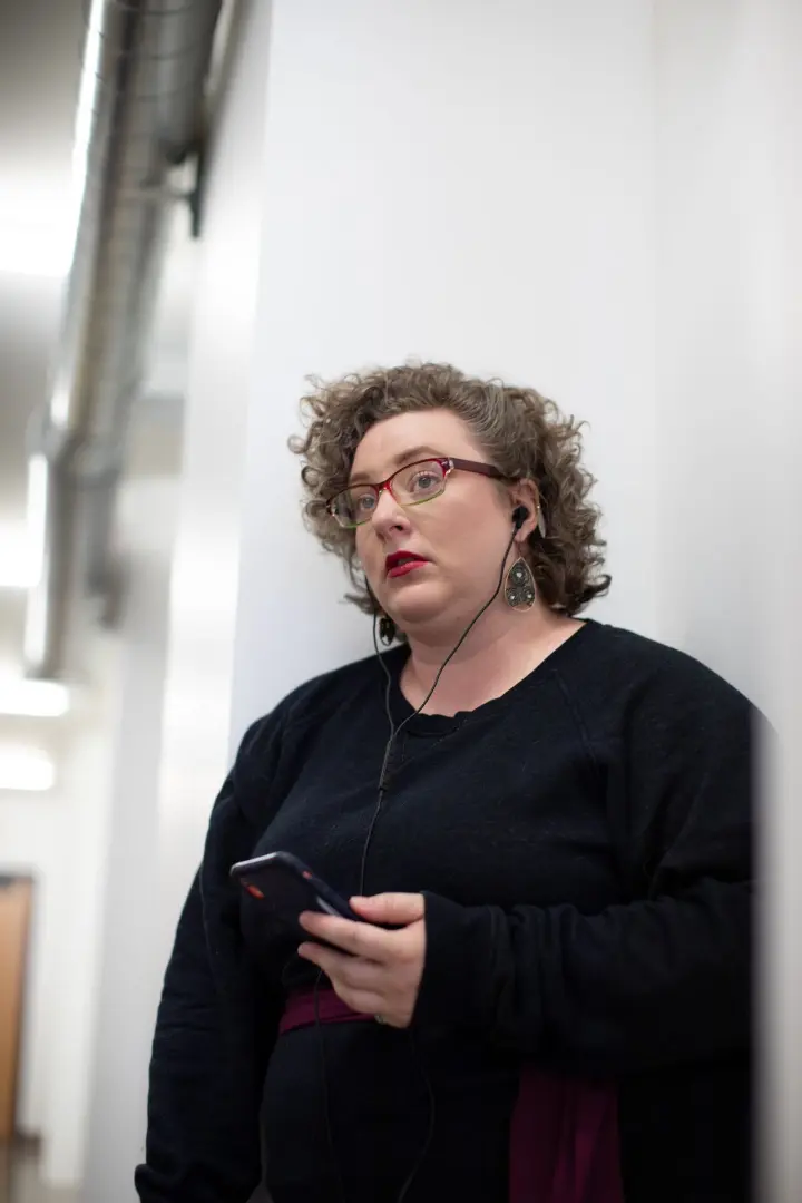 A leader looking stressed out while on a phone call at work.